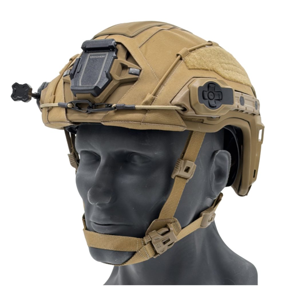 Tan tactical helmet with front-mounted night-vision goggle rail and chin strap visible on a mannequin head, showing accessory mounts.