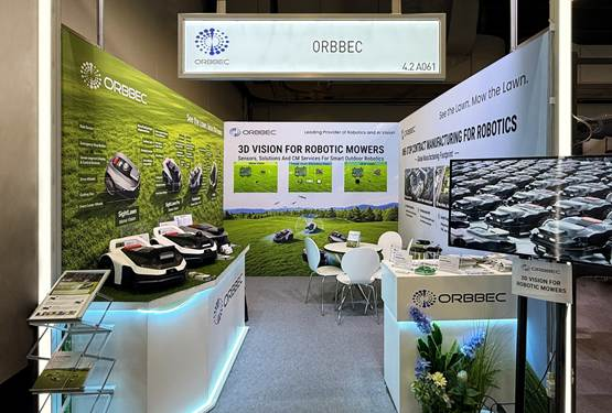 Exhibition booth for ORBBEC with 3D vision for robotic mowers, green banners, monitors, and a seating area.